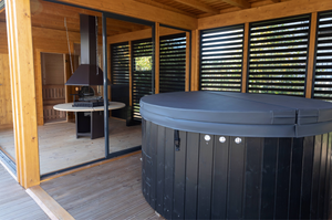 The interior of the Hot Tub section of the Garden Cube with black painted hot tub and matching accents on the walls