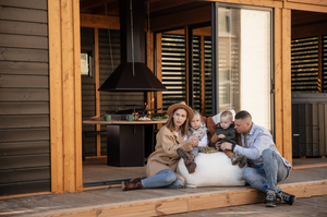 A family sat out on the front of the Garden cube - food cooking on the BBQ behind them