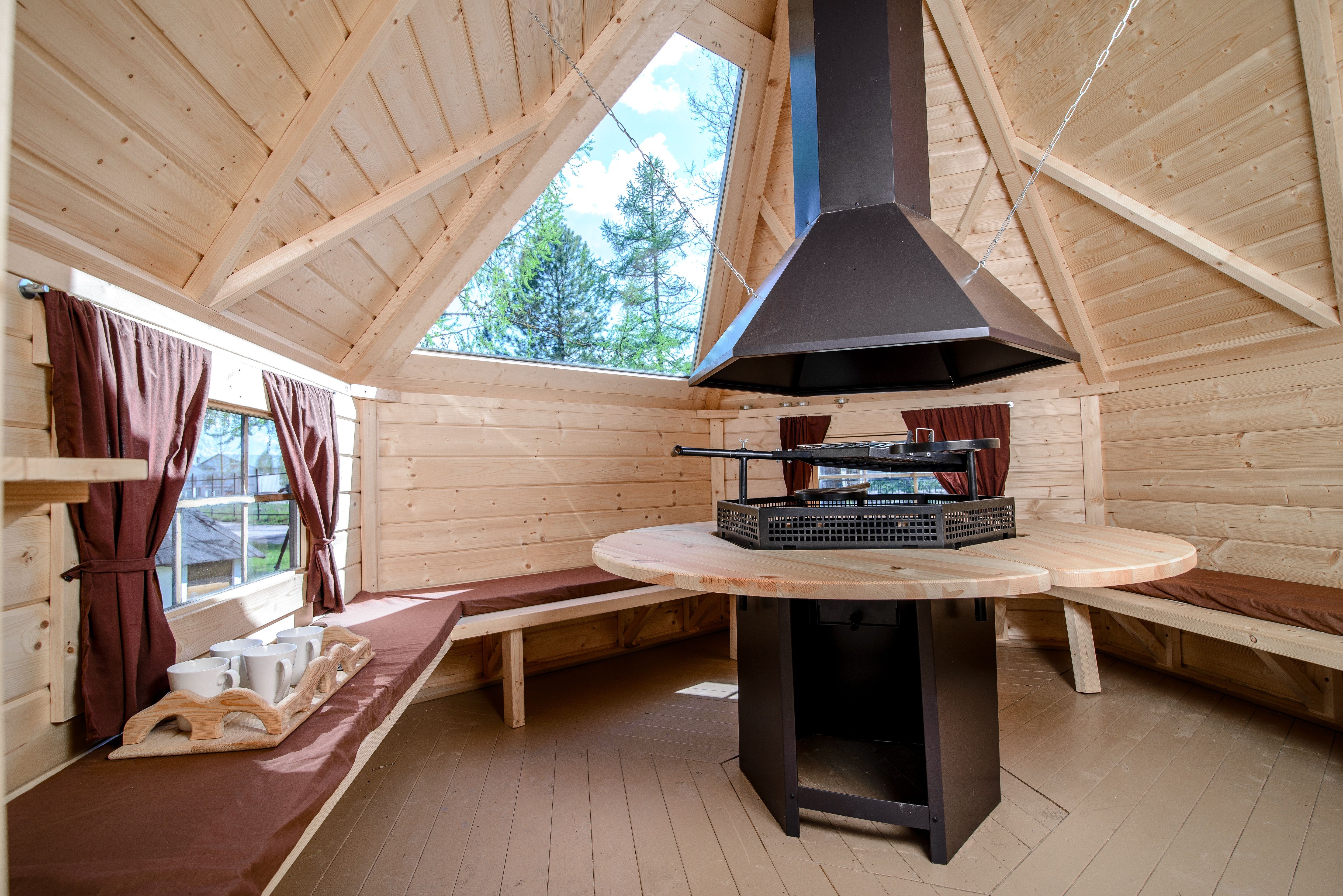 A BBQ Hut with a windowed roof panel showing the Premium grill in the centre.