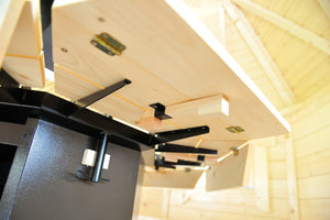 A photo showing the underside of the wooden tables that surround the outside of the BBQ Grill