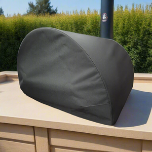 A back pizza oven cover for a pizza oven outdoor, set on an outdoor kitchen work top.