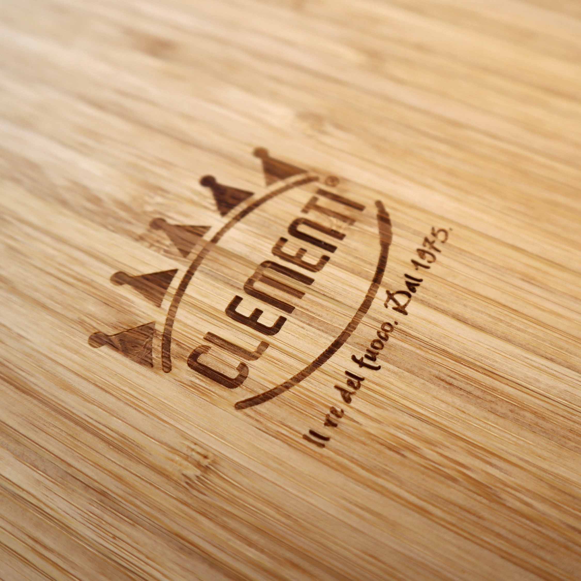 A close up shot of the Clementi Pizza Oven logo stylishly burnt into bamboo chopping board 