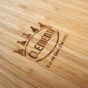 A close up shot of the Clementi Pizza Oven logo stylishly burnt into bamboo chopping board 