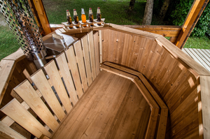 a top down image showing the interior of the hot tub with external heater a bottle holder on the side and benches for everyone inside.