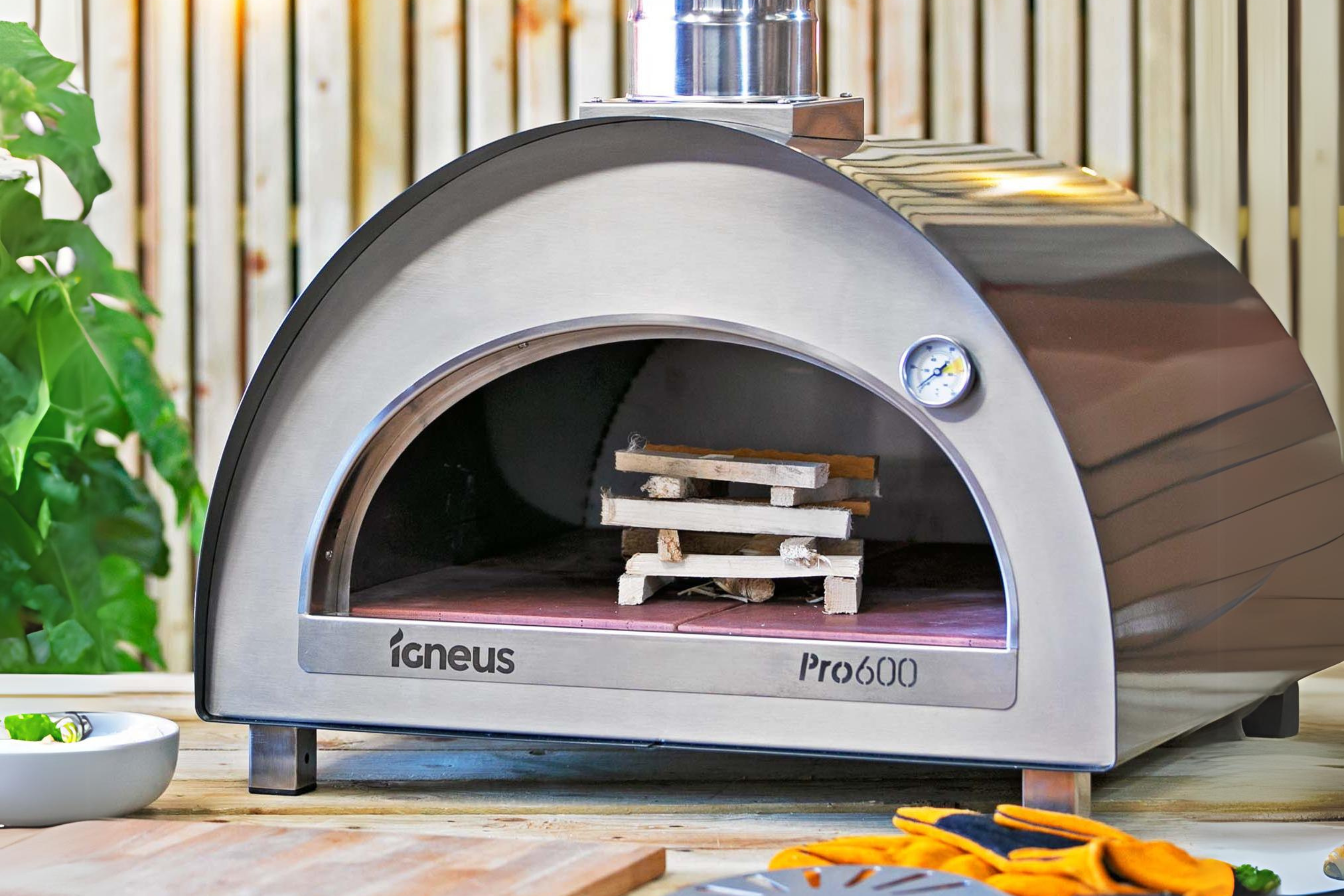 The Pro 600 wood fired pizza oven outdoor on a wooden table, ready to be lit