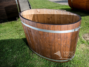 A side profile image showing the Viking Indsutrier cold tub on some green grass with other structures in the background.