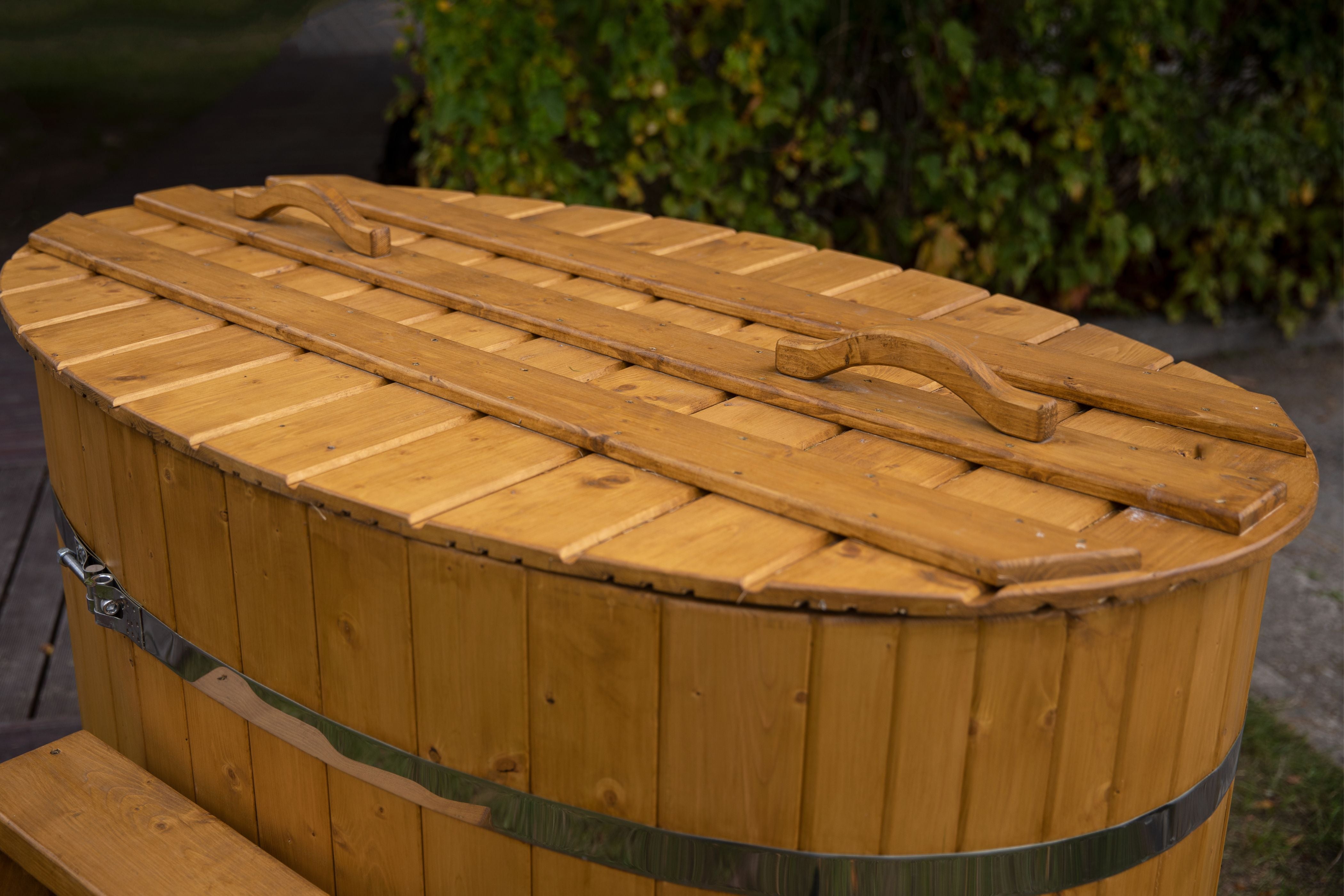 Aa close up image of the Viking Industrier cold tub in a light brown colour with some bushes in the background.