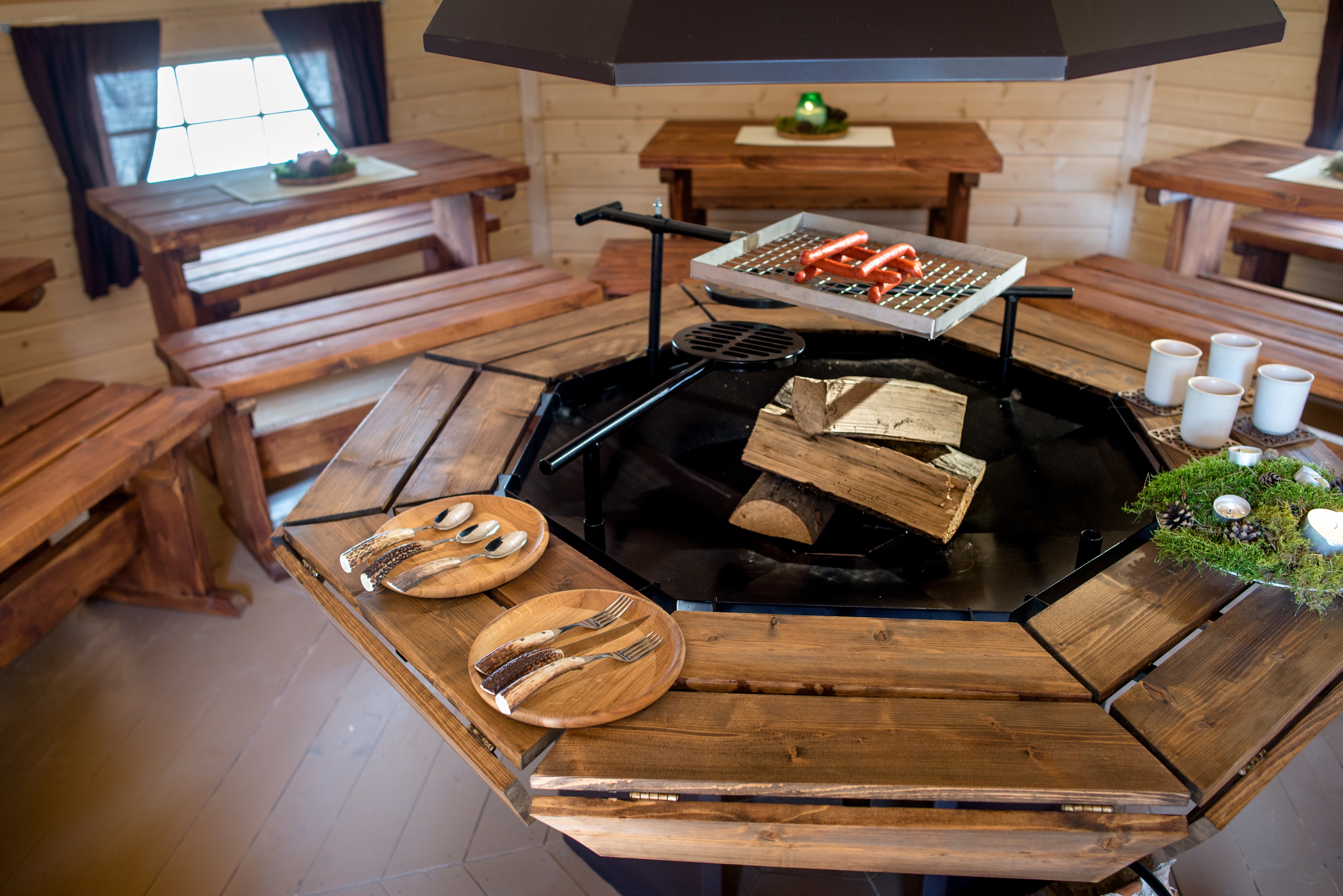 A Viking 8 corner grill set with logs laid ready to be lit - with a lovely dark oak finish.